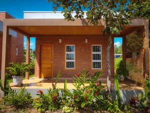a brick house with a porch and a door at ChapadaFlats in Chapada dos Guimarães