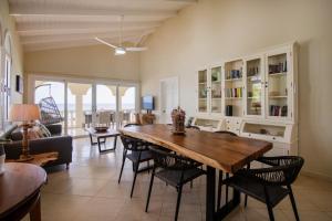 a living room with a large wooden table and chairs at Curacao Luxury Holiday Rentals in Willemstad