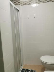 a white bathroom with a toilet and a shower at Alloggio del Barbarossa in Acquapendente