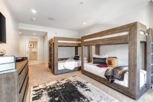 a bedroom with two bunk beds and a bathroom at Abode at Sky Silver in Park City
