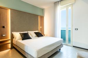 a bedroom with a large bed and a large window at Hotel Acquamarina Viserba in Rimini +96 photos
