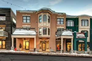 an apartment building with snow on the ground at Abode on Lower Main Street in Park City