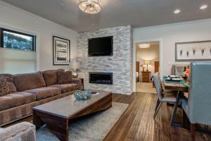 a living room with a couch and a fireplace at Abode on Lower Main Street in Park City