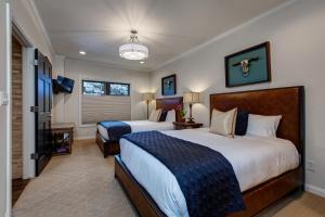 a hotel room with two beds and a television at Abode on Lower Main Street in Park City