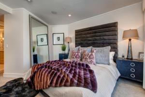 a bedroom with a large bed and a large mirror at Abode at Sky Silver Edge in Park City