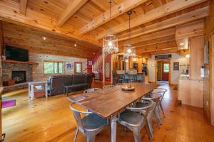 a dining room with a large wooden table and chairs at The Hygge Chalet by Railey Vacations in McHenry