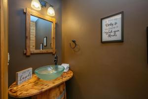 a bathroom with a bowl sink and a mirror at The Hygge Chalet by Railey Vacations in McHenry +29 photos