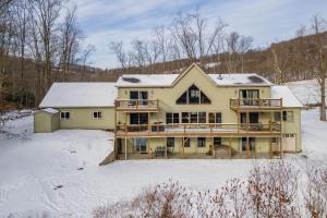 a large yellow house with snow on top of it at Mountain Paradise by Railey Vacations in Friendsville +49 photos