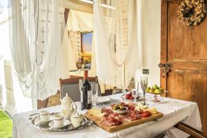 a table with a plate of food on it at La Suite Toscana in Certaldo