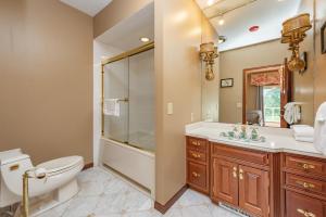 a bathroom with a toilet sink and a shower at The Herrington by Railey Vacations in Oakland