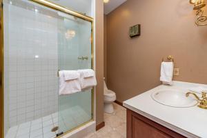 a bathroom with a sink and a glass shower at The Herrington by Railey Vacations in Oakland