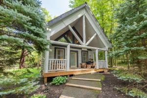 a tiny house in the woods with a porch at The Grizzly Den by Railey Vacations in Oakland