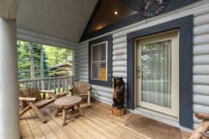 a porch with chairs and a clock on a house at The Grizzly Den by Railey Vacations in Oakland