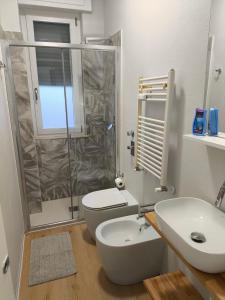 a bathroom with a shower and a toilet and a sink at Zuretti House in Milan +6 photos