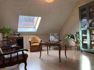 a living room with a table and a chair at Lo Saunei in Laruns +19 photos