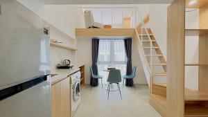 a kitchen with a staircase and a table and chairs at Arista - Thanh My Loi in Ho Chi Minh City