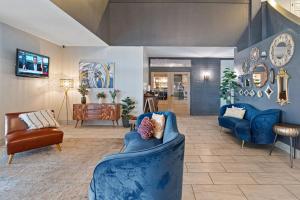 a living room with a blue couch and chairs at Plantation Inn in Houma
