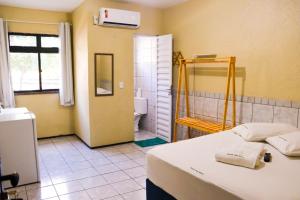 a bathroom with a bed and a shower and a toilet at Pousada Dom Manuel - Ce in Fortaleza