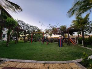 a park with a playground with a swing set at Studio Completo a 2min da Praia e Beach Park in Aquiraz