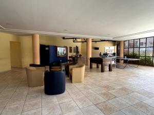 a lobby with chairs and a ping pong table at Studio Completo a 2min da Praia e Beach Park in Aquiraz