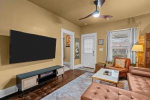 a living room with a flat screen tv on the wall at Quiet 2BR Near Mercy Dog Friendly, Week & MO Rates in Springfield