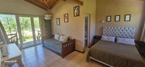 a living room with a bed and a couch at Loma Alta Apart in Villa Yacanto
