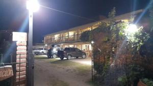 a truck parked in front of a building at night at El Pino Departamentos in Villa Cura Brochero