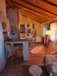 a living room with a desk and a bedroom at Linnis Strandhaus in Garrel
