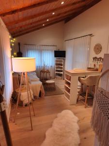 a room with a bed and a desk and a table at Linnis Strandhaus in Garrel