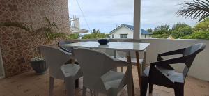 a white table and chairs on a balcony at Life and memory in Blue Bay +2 photos