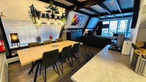 a dining room with a wooden table and chairs at Villa Edice met zwembad en restaurant in Durbuy - honden toegelaten in Durbuy