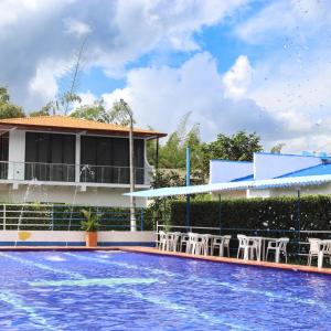a resort swimming pool with chairs and a building at Desiderata Resort in Guaduas +51 photos
