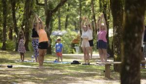 a group of people doing yoga in a park at ZEcamping 4 étoiles animaux acceptés piscine couverte in Loupiac +10 photos