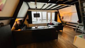 a living room with a couch and a window at Villa Edice met zwembad en restaurant in Durbuy - honden toegelaten in Durbuy +21 photos