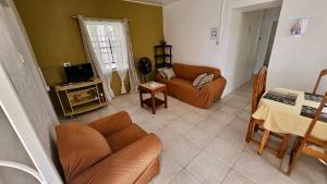 a living room with a couch and a table at Ventnor House Apartments in Bridgetown
