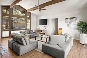 a living room with two couches and a flat screen tv at High Country Rretreat in Flagstaff