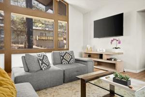 a living room with a couch and a flat screen tv at High Country Rretreat in Flagstaff