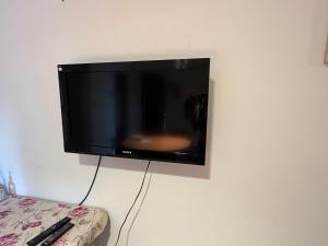 a flat screen tv hanging on a wall at Villa Paula in Ranchos