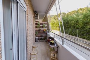 an apartment balcony with stools and a balcony with stairs at Cozy Spot in Ixia
