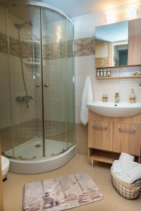 a bathroom with a shower and a sink at Cozy Spot in Ixia +25 photos