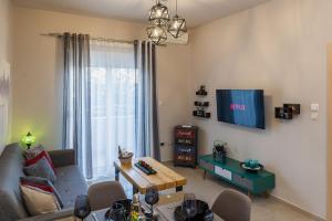 a living room with a couch and a tv at Cozy Spot in Ixia