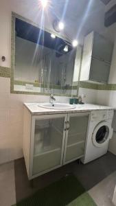 a bathroom with a sink and a washing machine at Casa in Piazzetta in Zagarolo