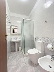 a white bathroom with a toilet and a sink at Affittacamere Seveso in Milan +18 photos