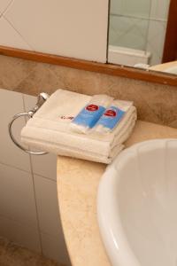 a bathroom with two towels on a counter next to a sink at Hotel Xumec Mendoza Centro in Mendoza +126 photos