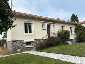 a house with a stone pathway in front of it at Mélusine - logement tout confort in Parthenay