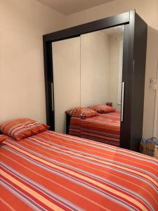 a bedroom with two beds and a large mirror at Mélusine - logement tout confort in Parthenay