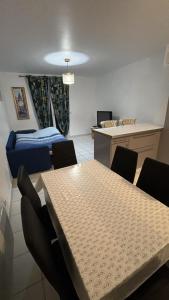 a room with a table and chairs and a bed at Maison a côté de Disney in Chessy