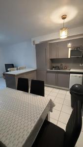 a kitchen with a table and chairs and a counter at Maison a côté de Disney in Chessy