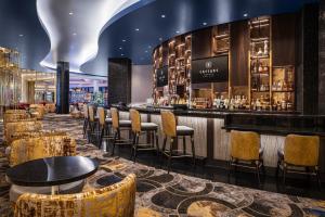 eine Bar in einem Hotel mit Stühlen und Tischen in der Unterkunft Caesars Virginia Hotel & Casino - A Caesars Rewards Destination in Danville