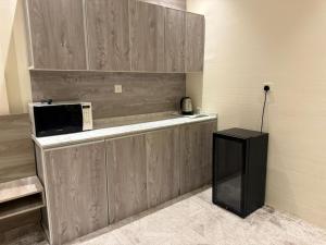 a microwave sitting on a counter in a kitchen at Marina Jada hotel in Jeddah